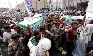Demonstrators carry the bodies of protesters