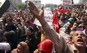 Protesters shout slogans against Egypt’s military council at Tahrir Square in Cairo