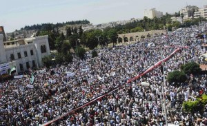 Syrian flag is held by the crowd