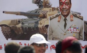 The banner reads Unite before the military tanks step on you. (Photo by Reuters)
