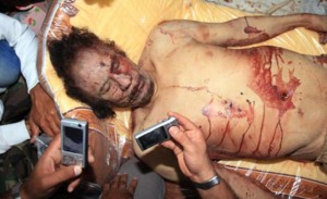 The bloodied body of Muammar Qaddafi