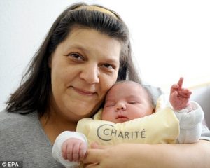 Jihad is cuddled by his mother, Elfi Yaghi, after being born at Berlin's Charité hospital over the weekend