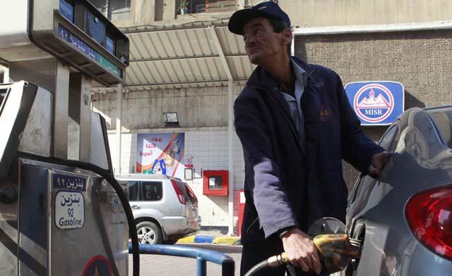 A worker pumps fuel at a petrol station in Cairo