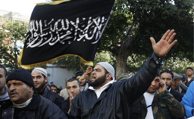 Protesters wave flags and shout “Allahu Akbar”