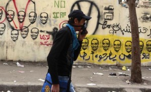 A young man wearing a tear gas mask