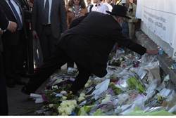 Lighting a candle in memory of Toulouse terror victims