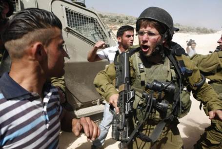 Arabs dare to attack armed soldiers near Yitzhar. Reuters