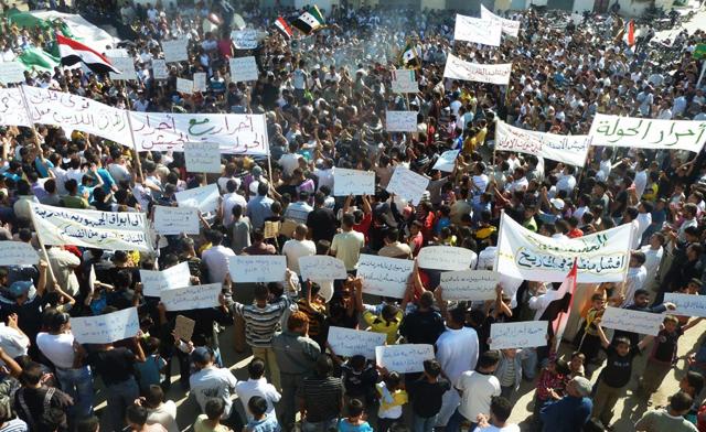Demonstrators march through the streets near Homs. Reuters