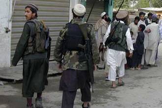 Taliban walk on a street