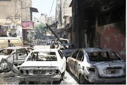 Burnt cars are seen on a street at al-Midan neighbourhood in Damascus Reuters
