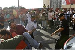 Members of the PA security forces beat demonstrators in Ramallah July 1 2012 (Reuters)