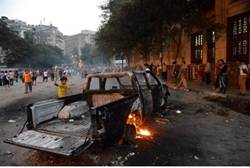 Burnt pick-up truck during clashes between protesters and riot police in Cairo - AFP