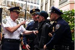 New York police arrest an Occupy Wall Street activist during demonstrations - reuters