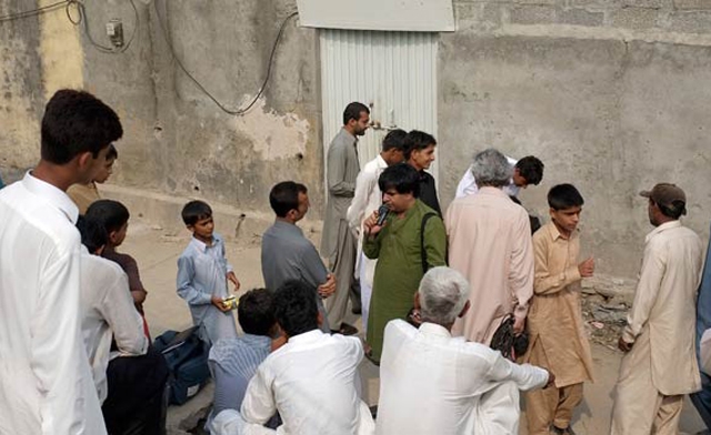 Residents gather outside the house of a Christian girl who was arrested on charges of blasphemy. (AP)