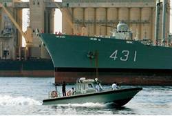 A Sudanese navy boat patrols close to a larger Iranian ship docked at Port Sudan -AFP