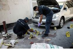 Bahraini police inspect the site of an explosion in the capital Manama