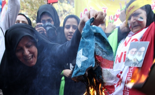 Iranian demonstrators burn a U.S. flag outside the former U.S. embassy in Tehran - AFP