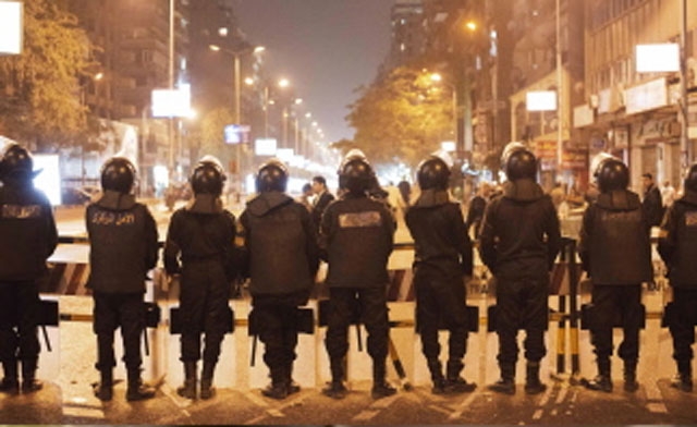 Egyptian riot police on the road leading to police station AFP