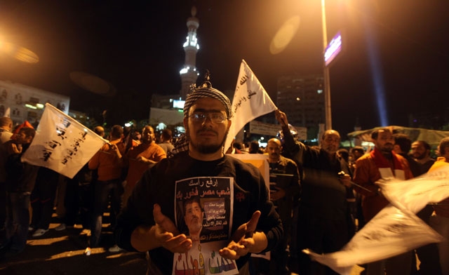 a supporter of Mursi wearing a piece of paper with Mursis picture . AFP