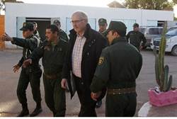 Algerian security escorts a freed hostage -Reuters