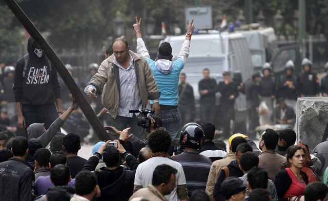 An Egyptian protester makes the sign of victory AFP