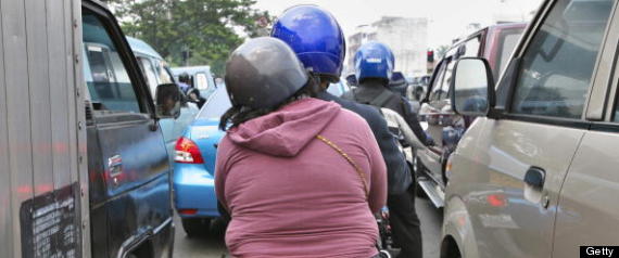 An Indonesian woman rides the back of a motorcycle BAY ISMOYO-AFP-Getty Images