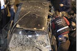 Security policemen inspect a damaged car in the suburbs of Beirut - Reuters