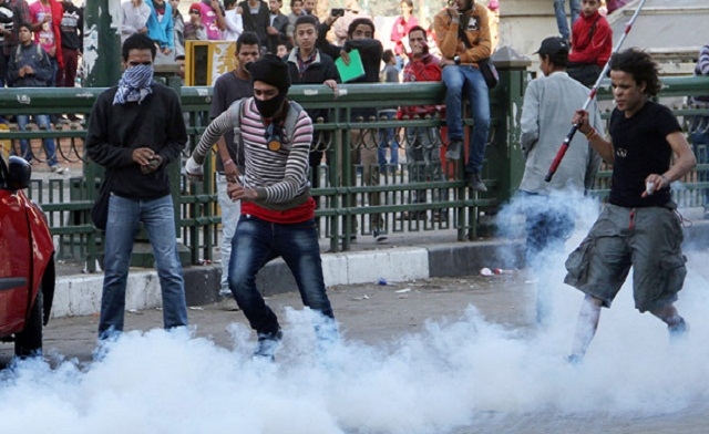 An Egyptian protester kicks a tear gas canister AFP