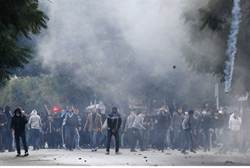 Protesters clash with riot police near the Interior Ministry in Tunis -Reuters