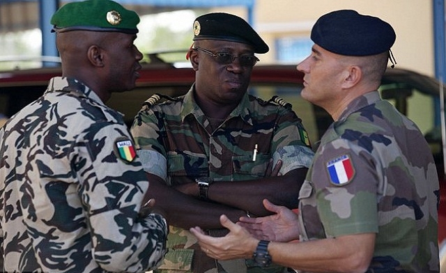 A French army officer right talks to his Malian in Bamako. Reuters