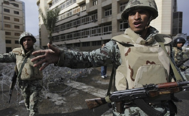 Egyptian army soldiers try to stop protesters during a protest in Port Said Reuters