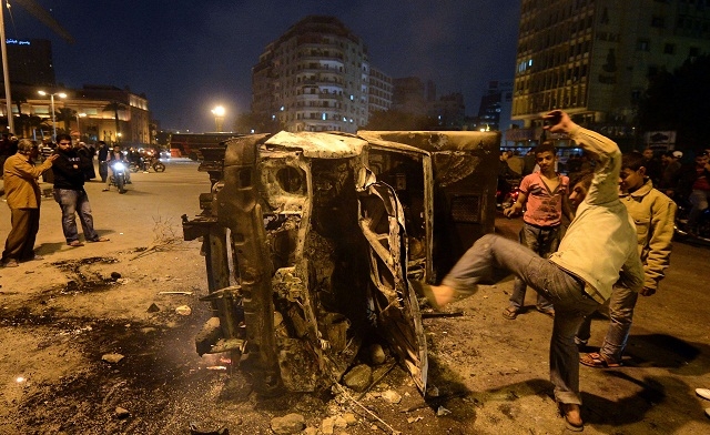 police vehicle that has been burnt by angry protesters on Tahrir square AFP