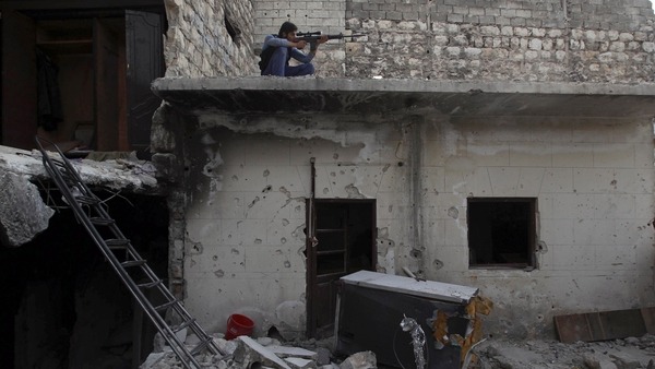 A Syrian Army fighter aims his rifle in Aleppos Karm al-Jabal district Reuters