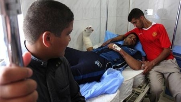 A wounded man lies on a hospital bed after bomb attacks Reuters