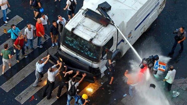 Protesters try to stop an armored crowd Reuters