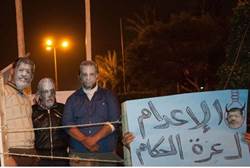 Protesters wear masks of Morsi and other Egyptian leaders -AFP