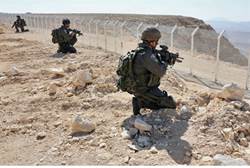Israeli soldiers stand guard at Sinai border