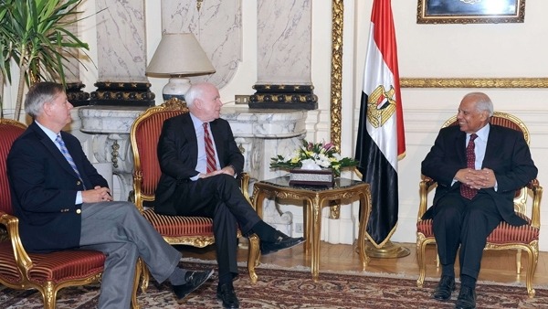 Egyptian Prime Minister Hazem el-Bablawi R meeting with U.S. senators John McCain C and Lindsey Graham L AFP