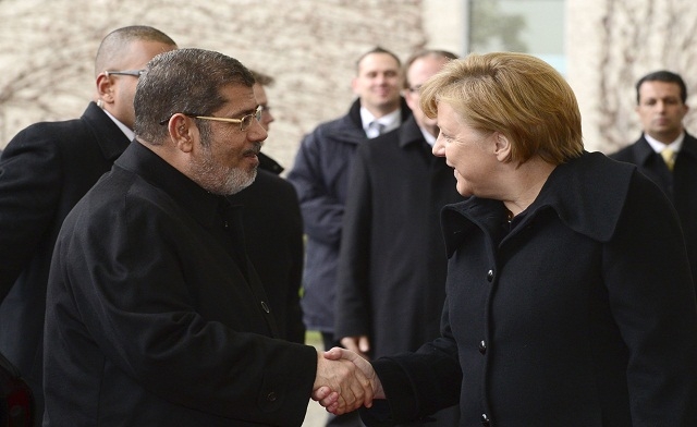 German Chancellor Angela Merkel shakes hands with Mohamed Mursi AFP