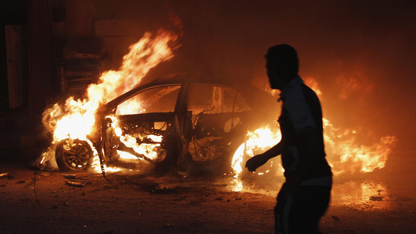 a car on fire at the site of a bomb attack in Baghdad Reuters