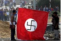 Palestinian Arabs hold Nazi flag at Netzarim Junction - Reuters