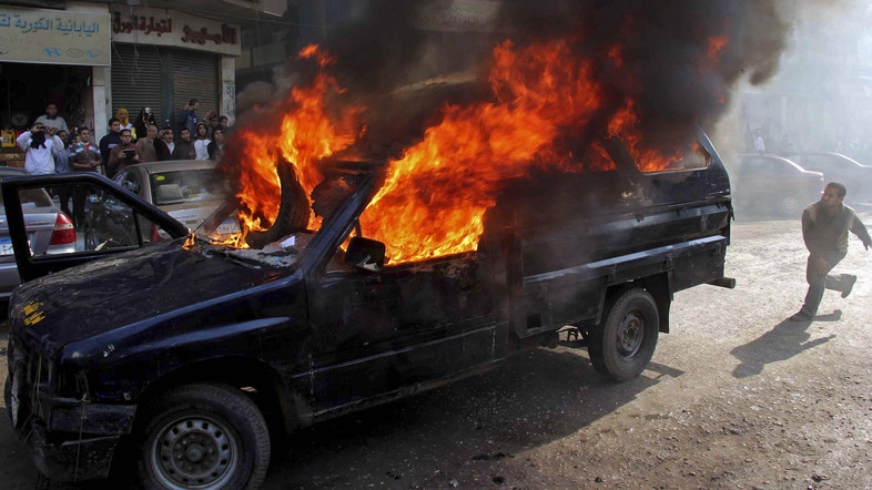 police vehicle on fire during clashes with terrorists at Nasr City district in Cairo Reuters